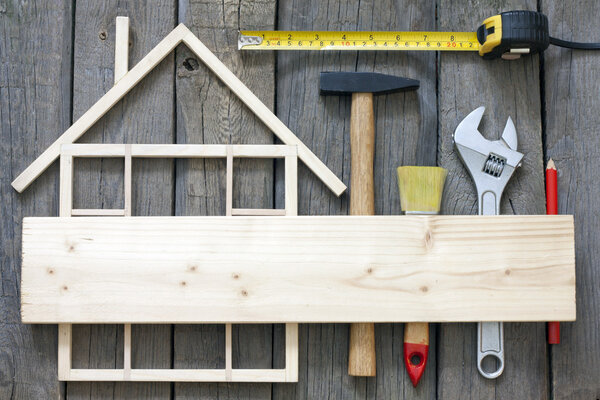 Wooden house construction renovation and tools background
