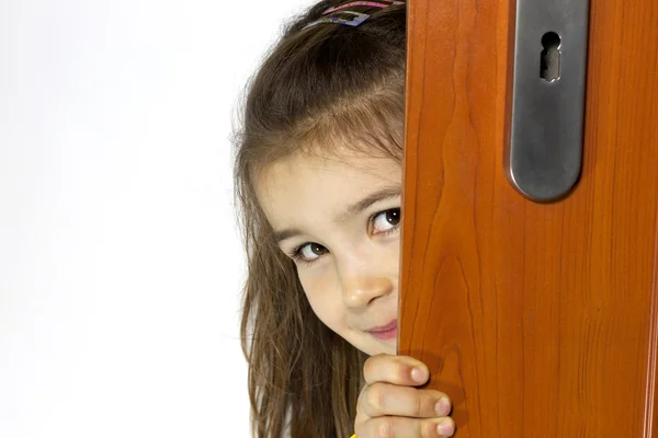 Girl opening the door and mysterious smiling — Stock Photo, Image