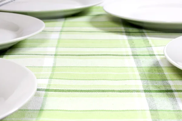 Plates on tablecloth in kitchen abstract food background — Stock Photo, Image