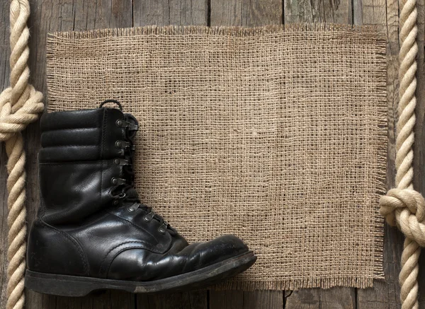 Old military shoes on wooden boards abstract background concept — Stock Photo, Image