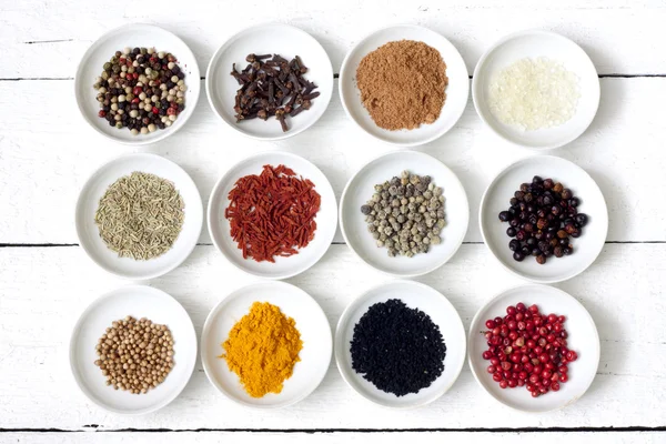 Spices and dried vegetables on vintage white planks — Stock Photo, Image