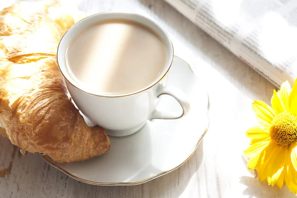 Croissant and cup of coffee in the morning closeup — Stock Fotó