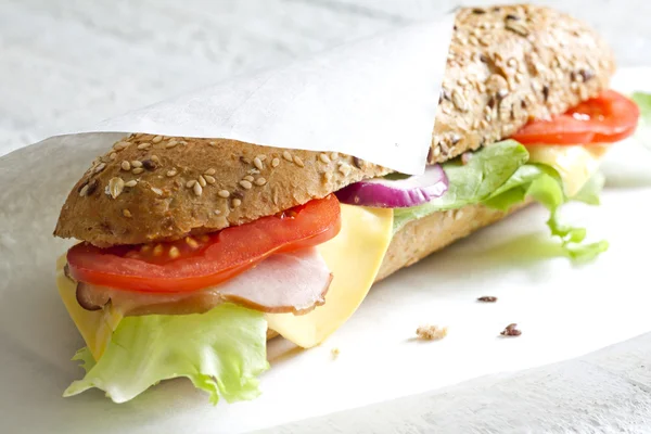 Sandwich on white paper — Stock Photo, Image