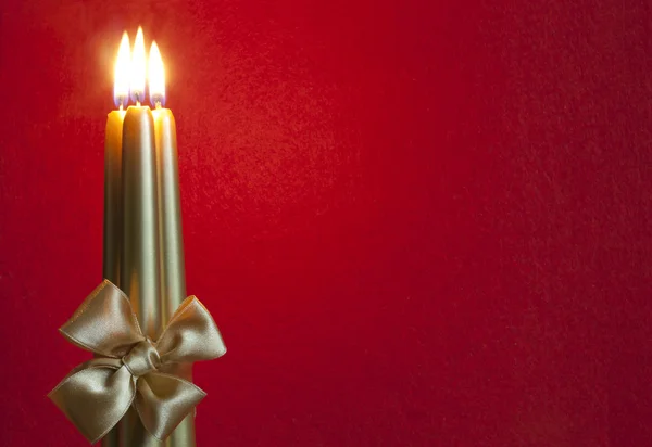 Abstract christmas background with candles on red fabric — Stock Photo, Image