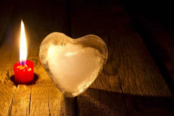 Ice heart and candle abstract Valentine s Day concept in night — Stock Photo, Image