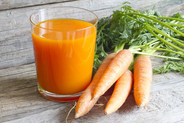 Carrot juice organic on wooden boards — Stock Photo, Image
