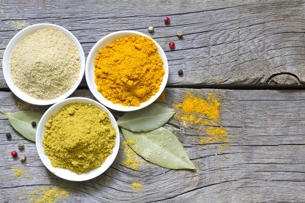 Herbs and dried spices on wooden board — Stock Photo, Image