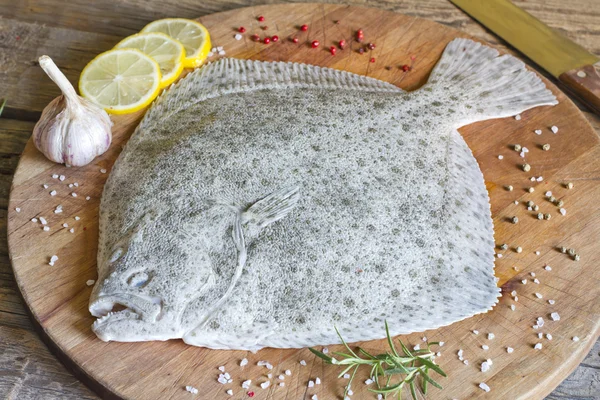 Turbot fish in the kitchen on cutting board — Stock Photo, Image