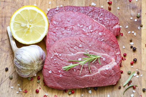 Beef steak with spices on board — Stock Photo, Image