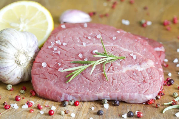 Beef steak with spices on board — Stock Photo, Image