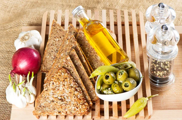 Tasty grain bread with olives and spices — Stock Photo, Image