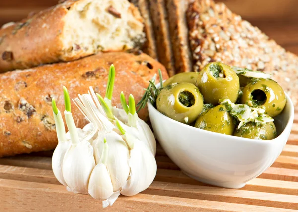 Olives and garlic with tasty Italian bread — Stock Photo, Image