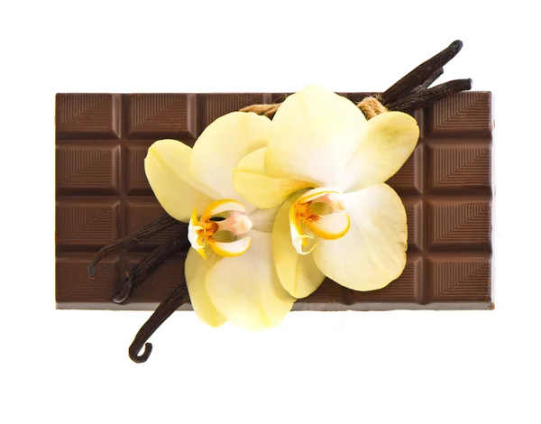 Chocolate with vanilla pods and orchid flowers — Stock Photo, Image