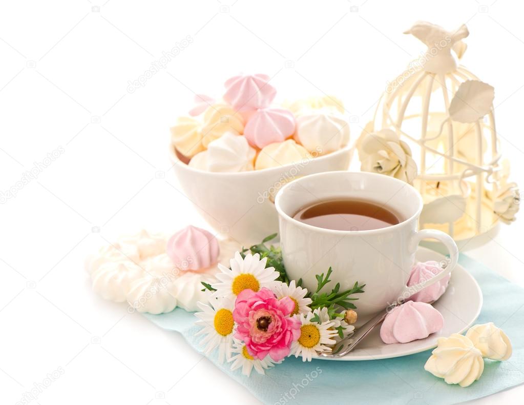 cup of tea with flowers and sweets