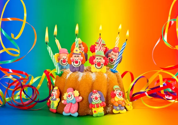 Birthday cake with candles and streamer — Stock Photo, Image