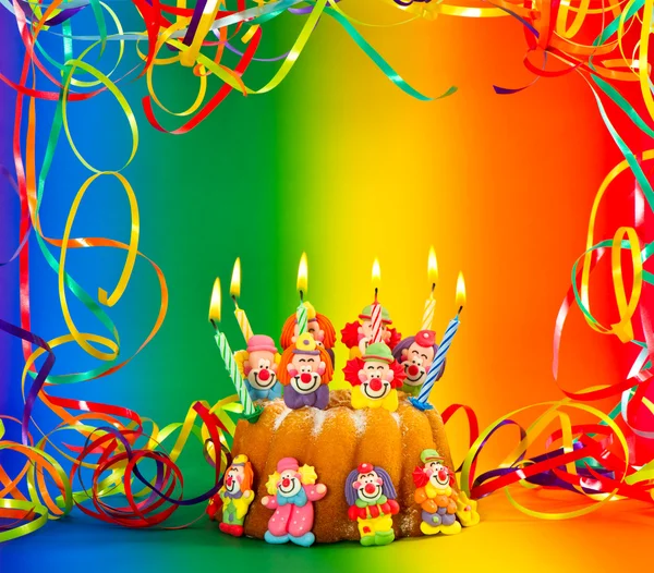 Birthday cake with sugar clowns decoration and candles — Stock Photo, Image