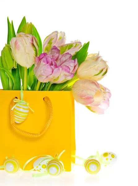 Tulipes fraîches de printemps en sac jaune avec décoration aux œufs de Pâques — Photo