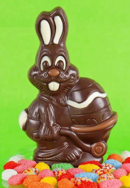Chocolate bunny with easter egg and colorful candies — Stock Photo, Image