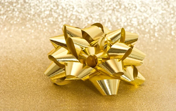 Golden bow on shiny background — Stock Photo, Image