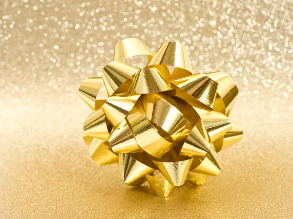 Beautiful golden bow on shiny background — Stock Photo, Image