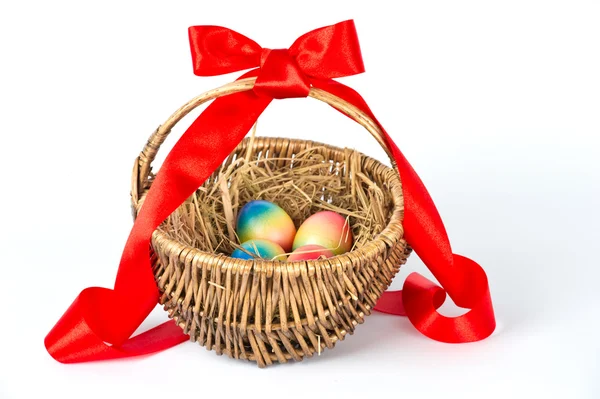 Colorful painted easter eggs in brown basket — Stock Photo, Image