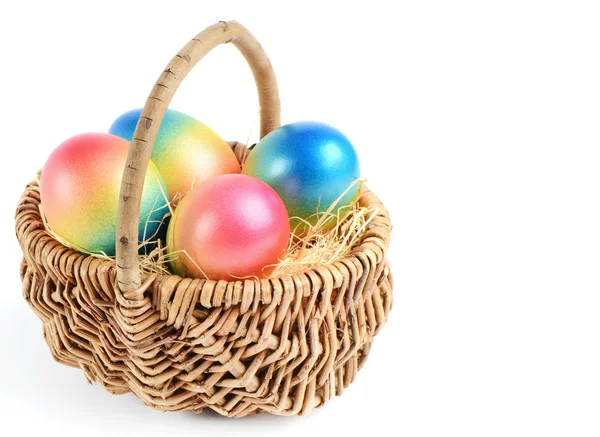 Colorful painted easter eggs in brown basket — Stock Photo, Image