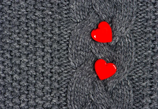 Red hearts of knitted wool background — Stok fotoğraf