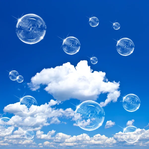 Soap bubbles on cloudy blue sky