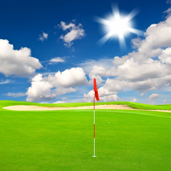 Golf field with cloudy blue sky background — Stock Photo, Image