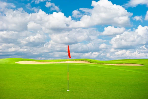 Green golf field with cloudy sky background — Stock Photo, Image