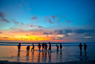 Young at sunset beach in Kuta, Bali clipart