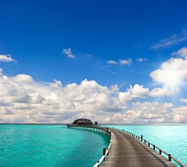 tropical seascape. overwater bungalow clipart