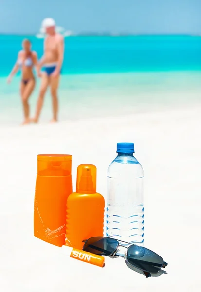 Sun protection cream water and sun glasses. — Stock Photo, Image