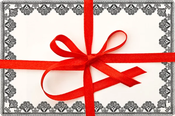 Gift card with red ribbon and lace frame — Stock Photo, Image