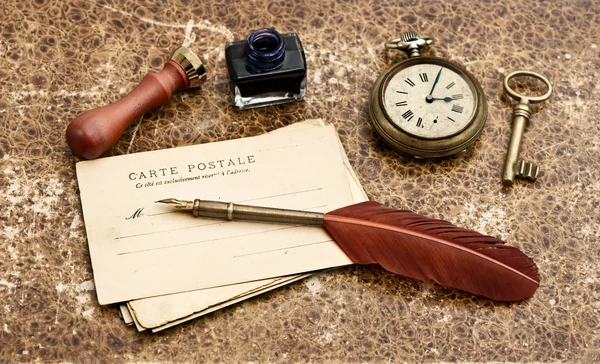 Vintage background with old post cards and feather pen — Stock Photo, Image