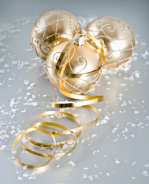 Golden christmas balls with snow decoration — Stock Photo, Image