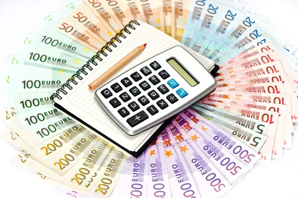 Calculator and note book on euro banknotes background — Stock Photo, Image