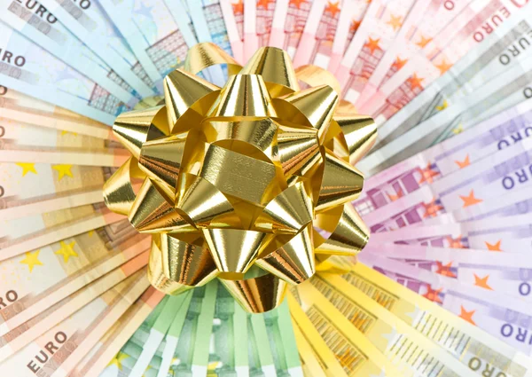 Money as a gift. golden ribbon on euro banknotes — Stock Photo, Image