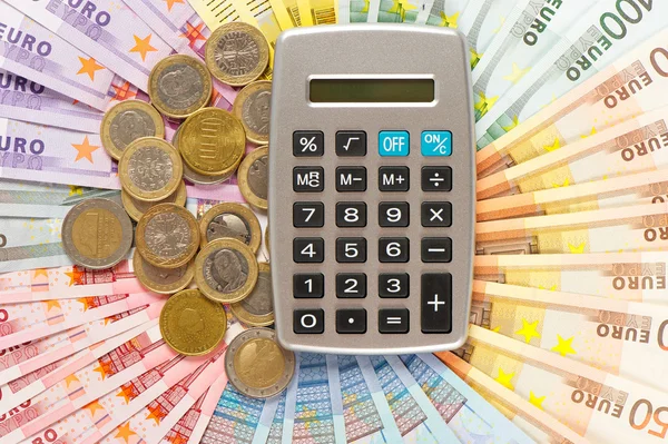 Calculator on euro coins and banknotes background — Stock Photo, Image