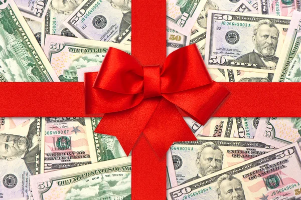 Red gift ribbon bow over american dollars — Stock Photo, Image
