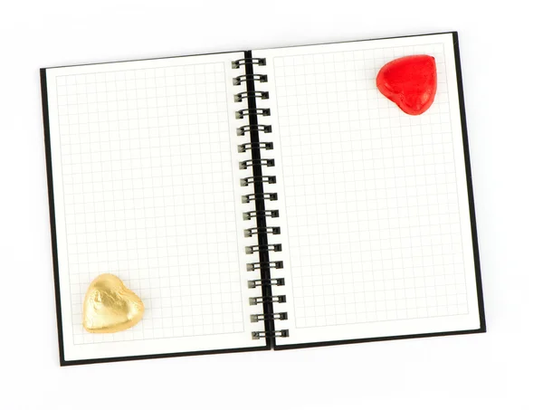 Open note book with chocolate hearts — Stock Photo, Image