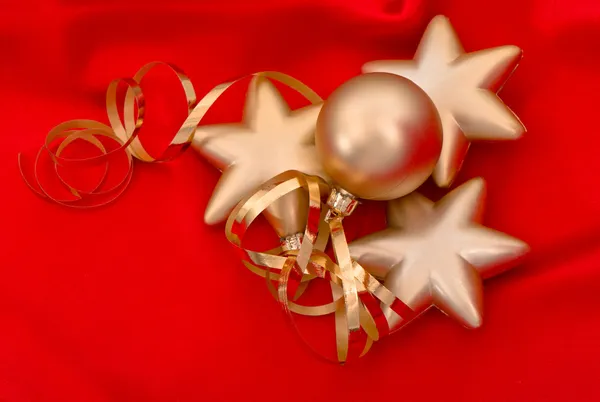 Golden christmas balls over red silk background — Stock Photo, Image