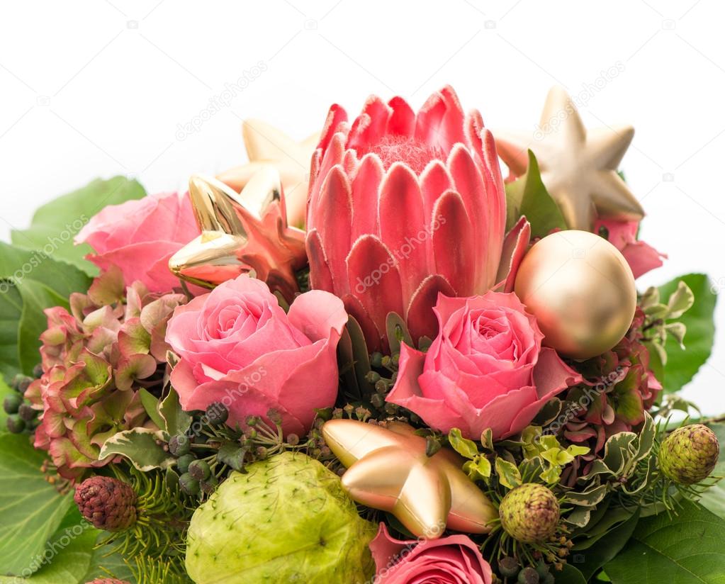 Fresh pink roses with golden christmas baubles