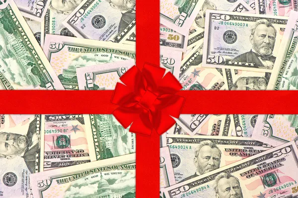 Red gift ribbon with bow over american dollars — Stock Photo, Image