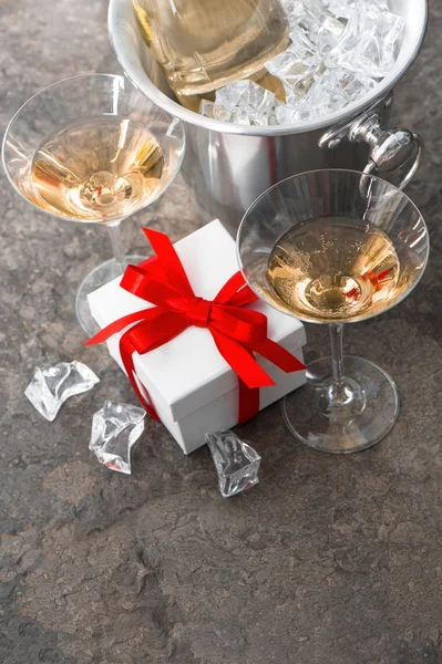 Two glasses, bottle of champagne and gift box — Stock Photo, Image