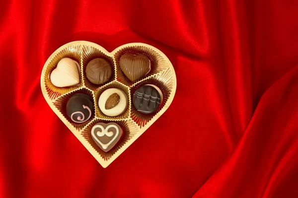 Pralinés de chocolate en caja de forma de corazón dorado. Día de San Valentín —  Fotos de Stock