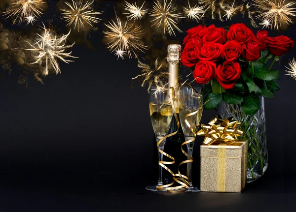 Bottle of champagne with golden fireworks on black — Stock Photo, Image