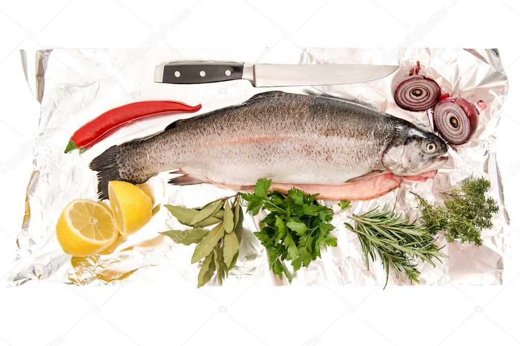 Raw salmon trout fish with fresh herbs and spices