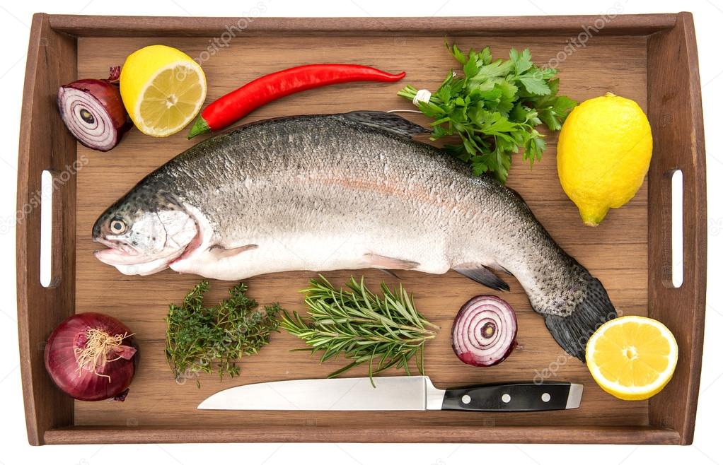 Raw salmon trout fish on wooden background