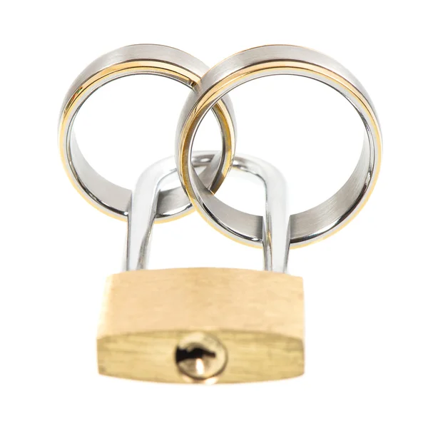 Wedding rings and key lock over white — 스톡 사진